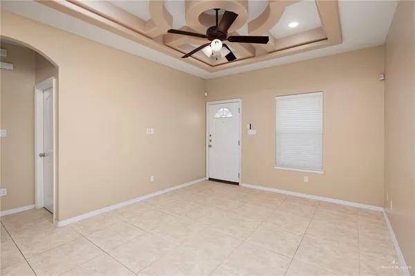 a view of an empty room and a ceiling fan