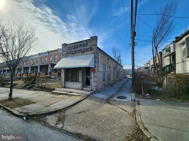 a view of a house with wooden fence