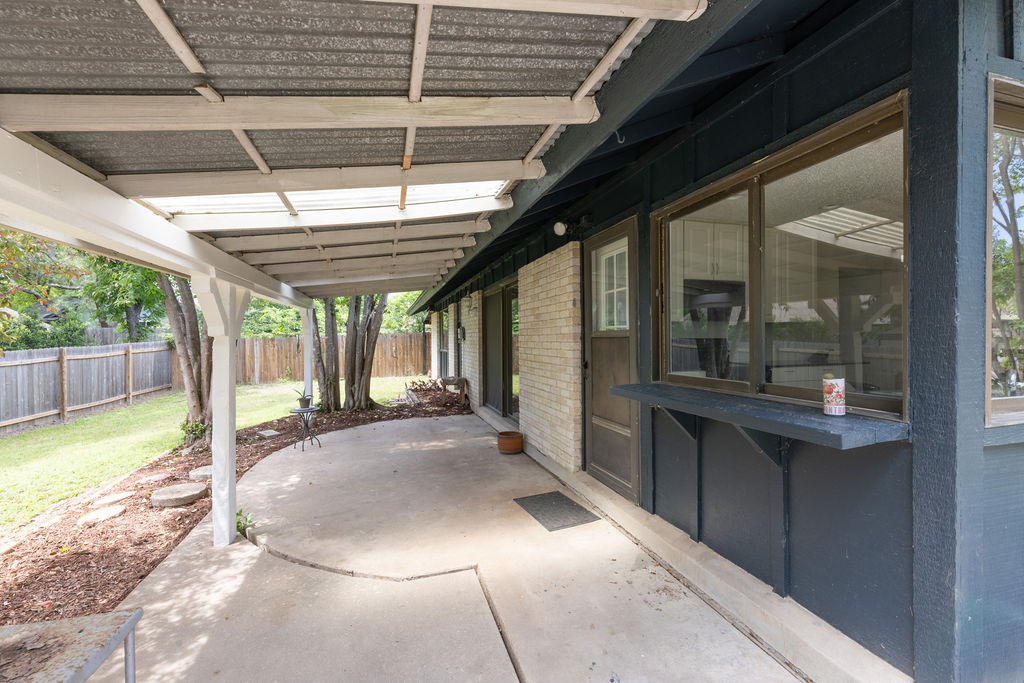 5310 Presidio Road Austin, TX 78745 - Photo 30 of 34 A spacious covered patio extends along the house, offering ample outdoor living space.