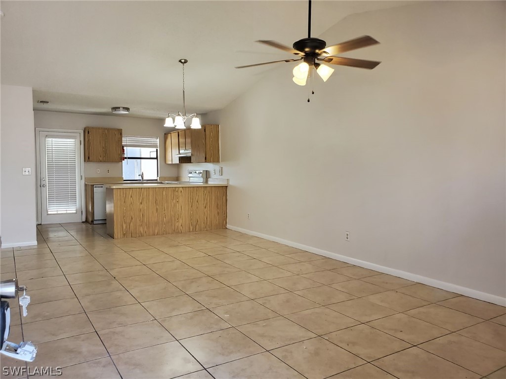 7510-7512 Love Road Fort Myers, FL 33967 - Photo 11 of 16 a living room with a table chairs and a chandelier