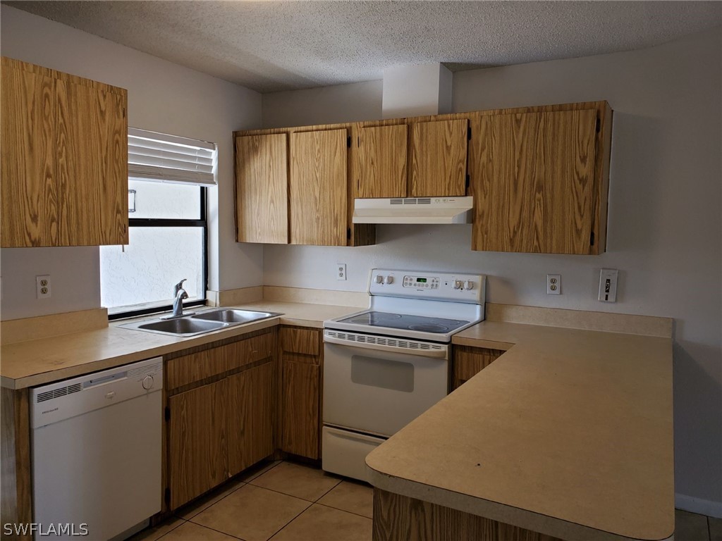 7510-7512 Love Road Fort Myers, FL 33967 - Photo 12 of 16 a kitchen with a sink stove and cabinets