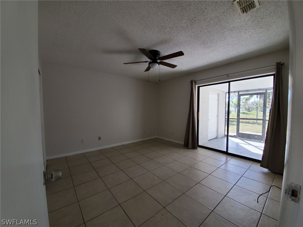 7510-7512 Love Road Fort Myers, FL 33967 - Photo 13 of 16 an empty room with chandelier fan and windows