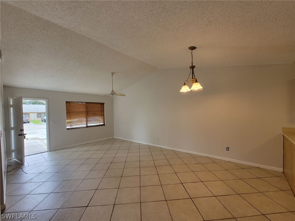 7510-7512 Love Road Fort Myers, FL 33967 - Photo 3 of 16 an empty room with windows and chandelier