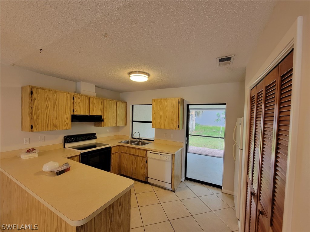 7510-7512 Love Road Fort Myers, FL 33967 - Photo 5 of 16 a kitchen with a sink appliances and cabinets