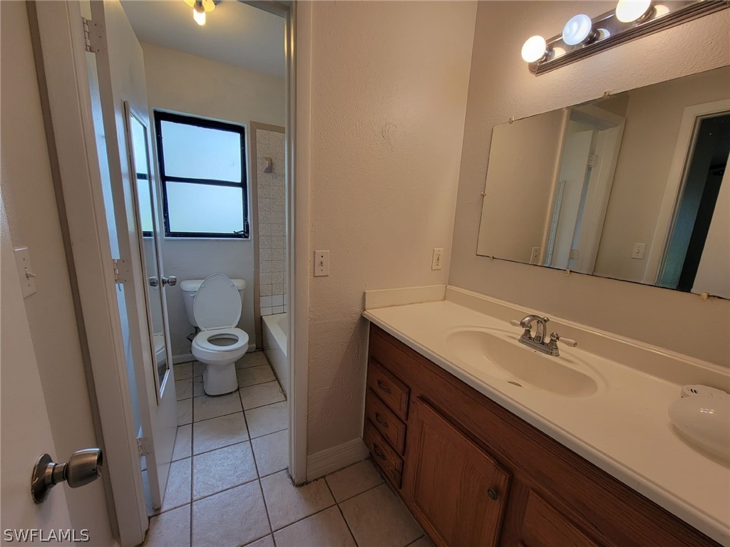 7510-7512 Love Road Fort Myers, FL 33967 - Photo 6 of 16 a bathroom with a sink a toilet and mirror