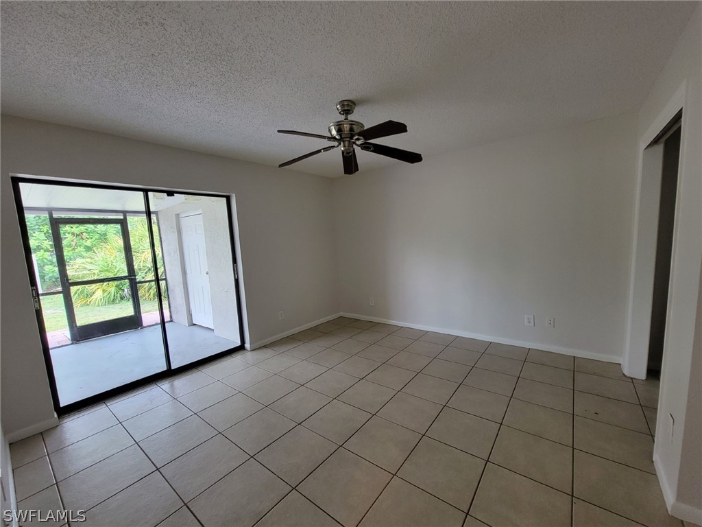 7510-7512 Love Road Fort Myers, FL 33967 - Photo 7 of 16 an empty room with windows and fan