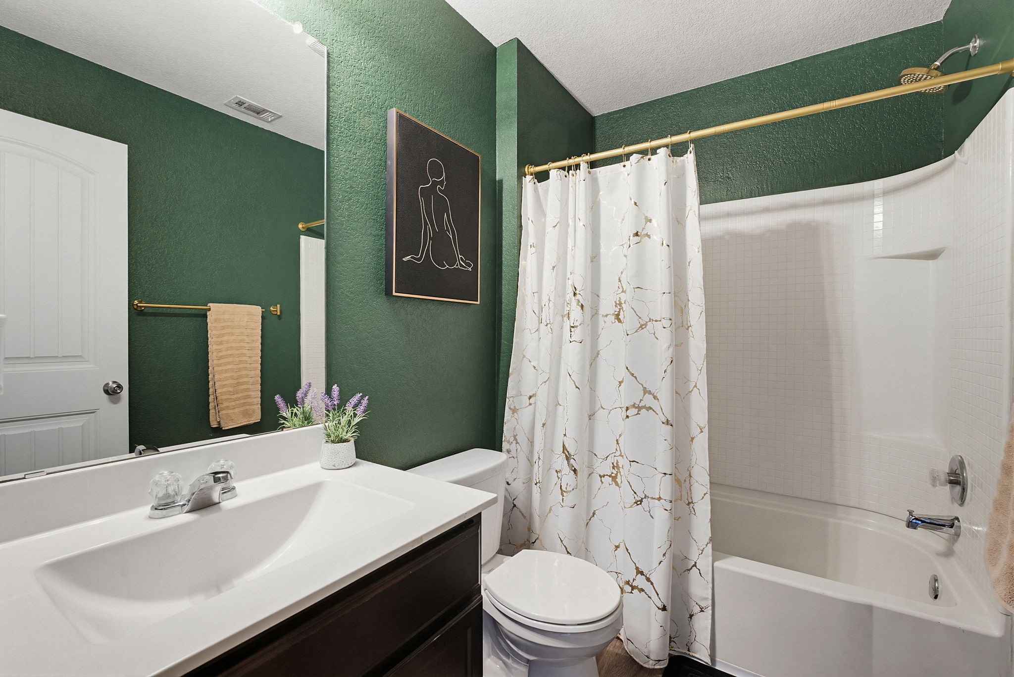 5805 Brampton Lane Austin, TX 78724 - Photo 13 of 17 Bathroom featuring vanity, shower / bath combo with shower curtain, and a textured wall