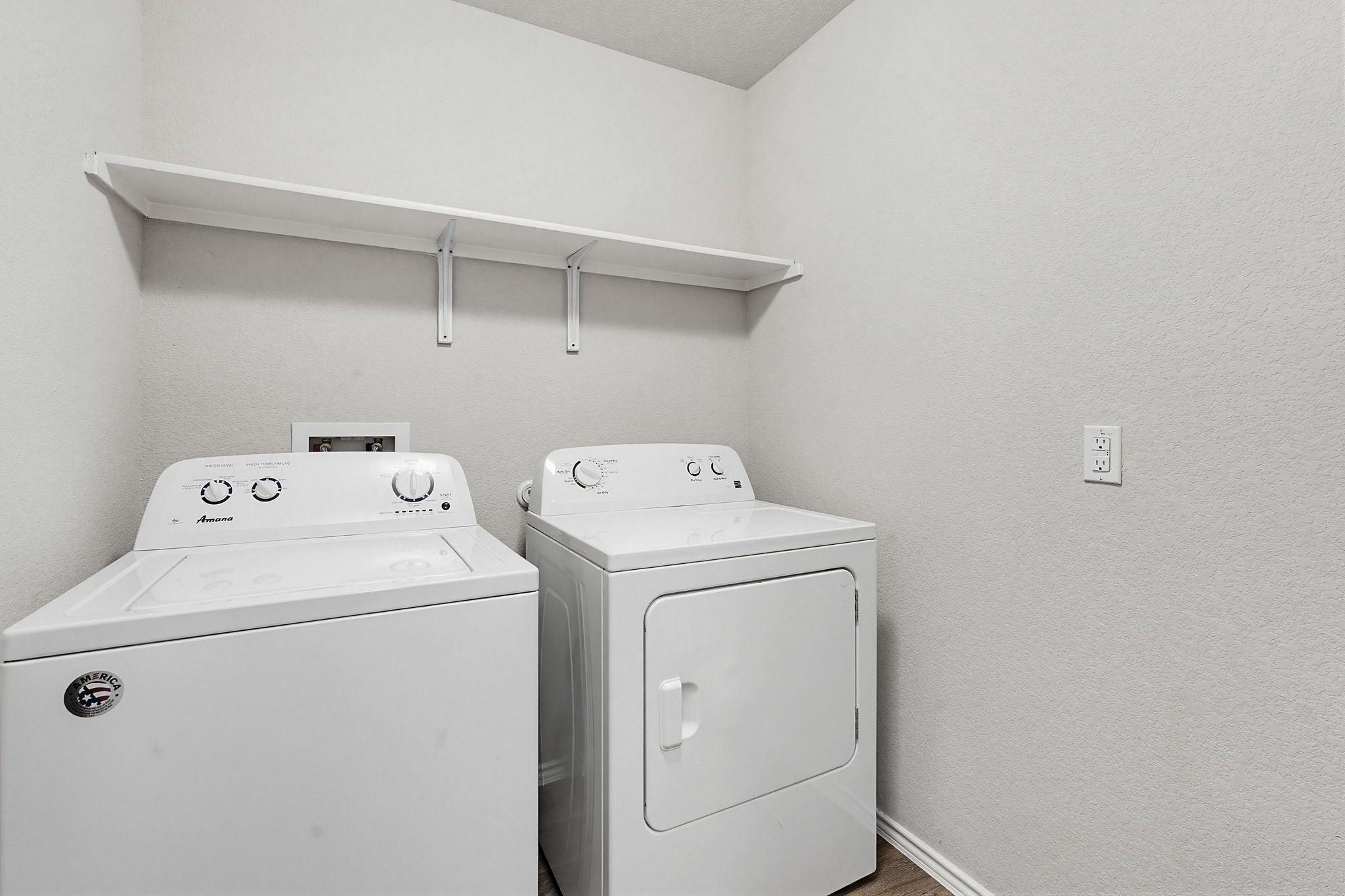 5805 Brampton Lane Austin, TX 78724 - Photo 14 of 17 Laundry area featuring washer and dryer, a textured wall, and wood finished floors