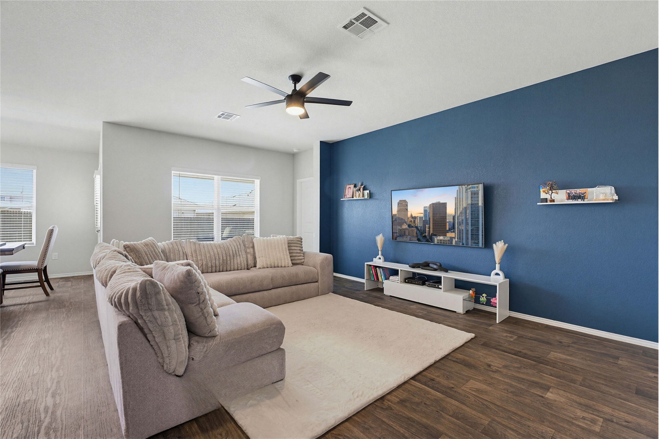 5805 Brampton Lane Austin, TX 78724 - Photo 3 of 17 Living area with a ceiling fan and dark wood-type flooring