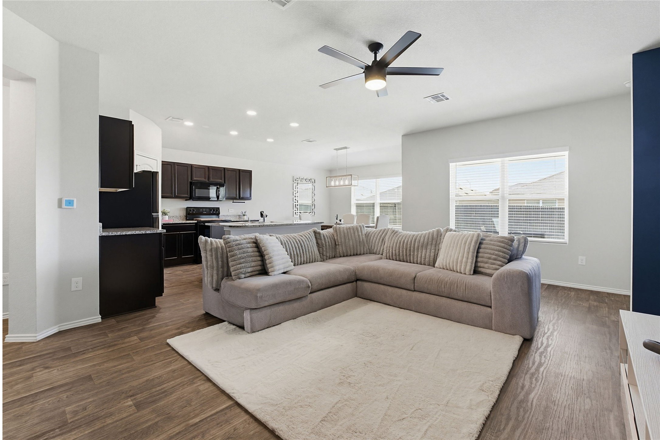 5805 Brampton Lane Austin, TX 78724 - Photo 4 of 17 Living room featuring a ceiling fan, dark wood-style floors, and recessed lighting