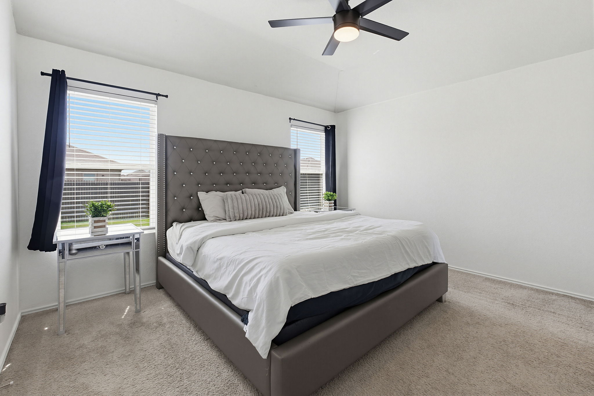 5805 Brampton Lane Austin, TX 78724 - Photo 7 of 17 Bedroom with light carpet, vaulted ceiling, and a ceiling fan