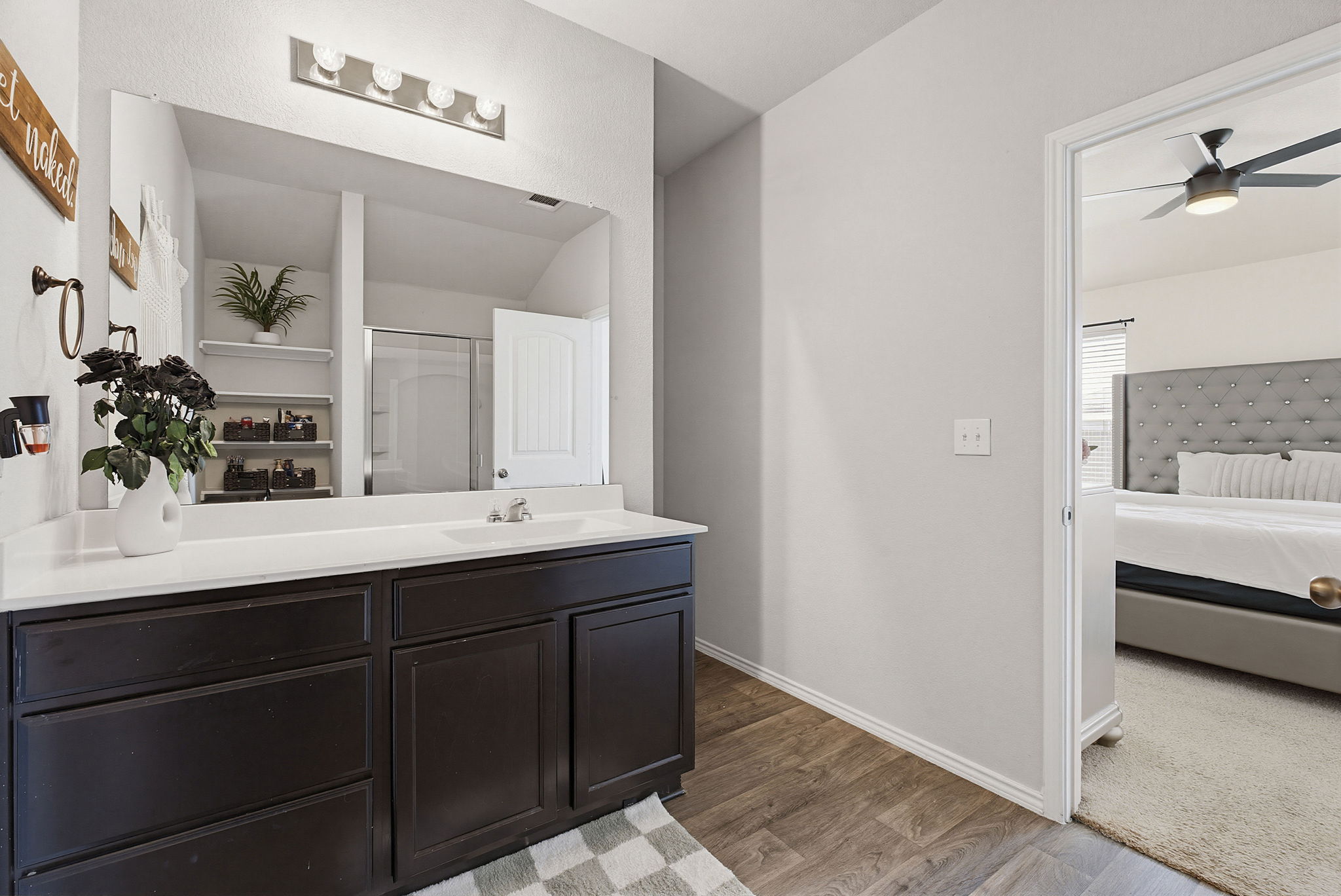 5805 Brampton Lane Austin, TX 78724 - Photo 10 of 17 Full bath with ensuite bathroom, vanity, light wood-style flooring, ceiling fan, and a shower stall