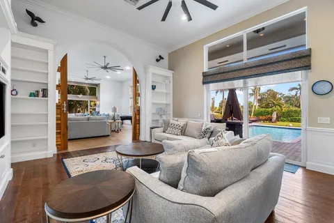 an aerial view of residential houses with outdoor space and lake view