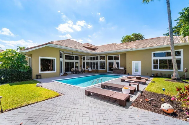 a view of a house with swimming pool and sitting area