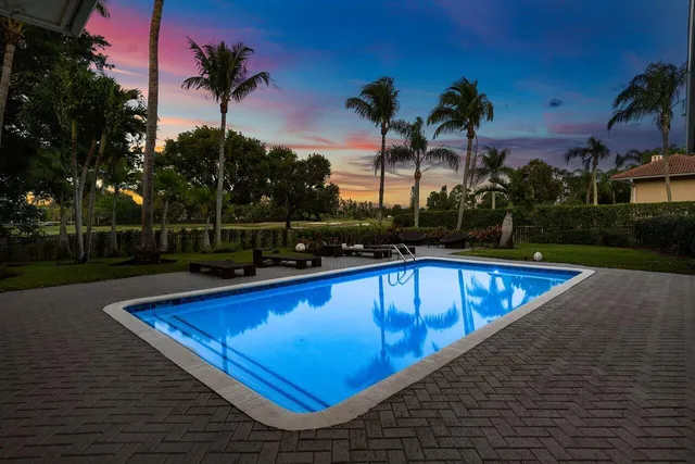 a view of a swimming pool with a table and chairs