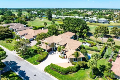 a kitchen with stainless steel appliances a refrigerator a sink dishwasher a stove and white cabinets with wooden floor