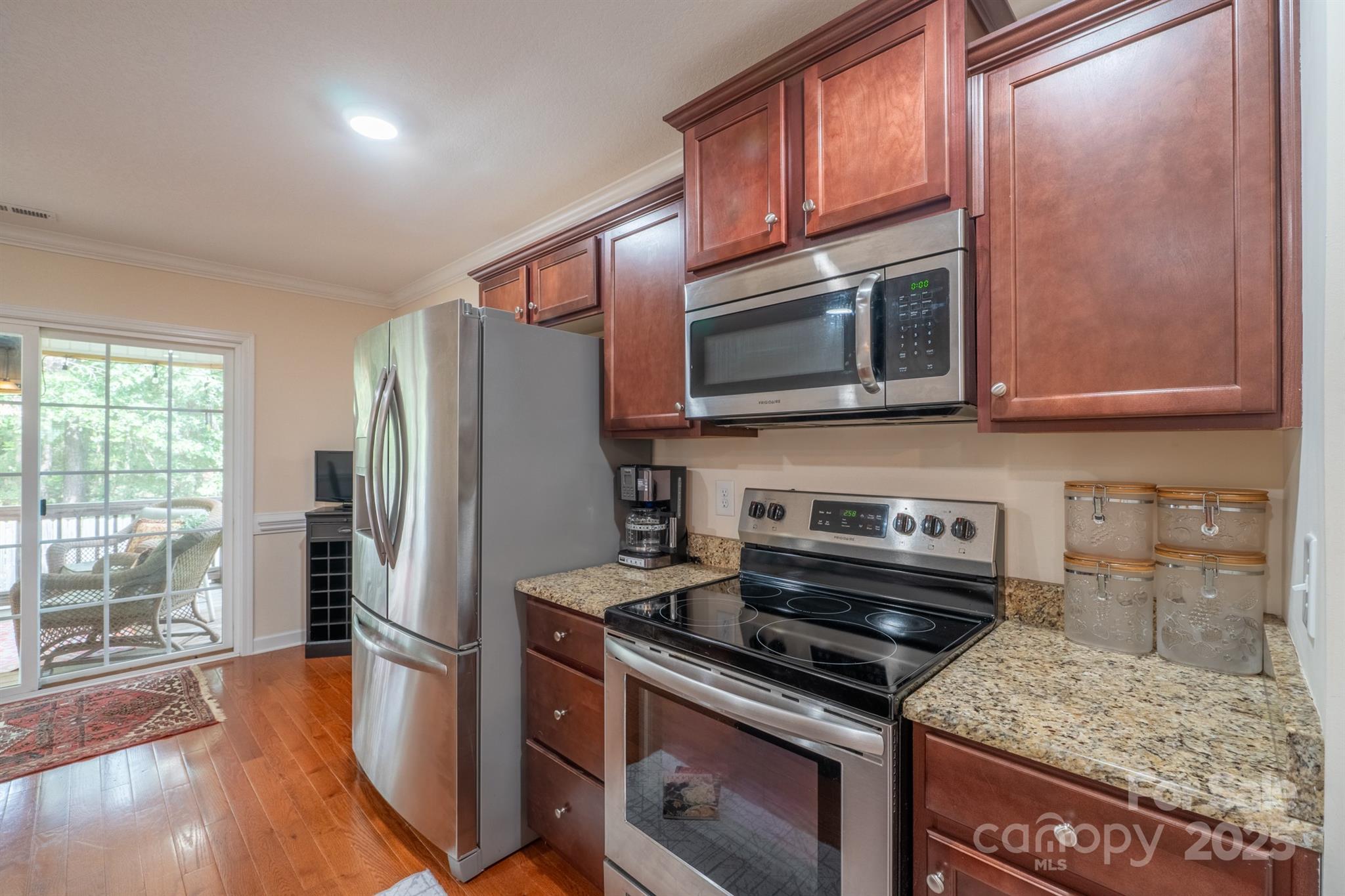 1812 Sam Smith Road Fort Mill, SC 29708 - Photo 15 of 43 a kitchen with stainless steel appliances granite countertop a stove microwave and refrigerator