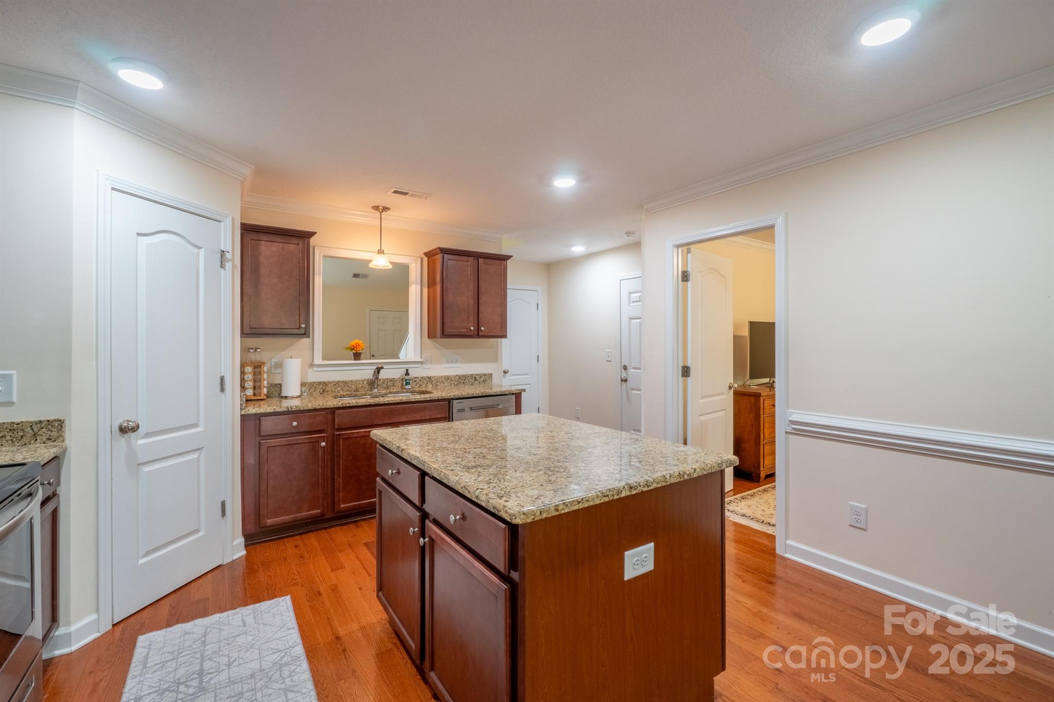 1812 Sam Smith Road Fort Mill, SC 29708 - Photo 16 of 43 a kitchen with stainless steel appliances granite countertop a sink and dishwasher a refrigerator with wooden floor