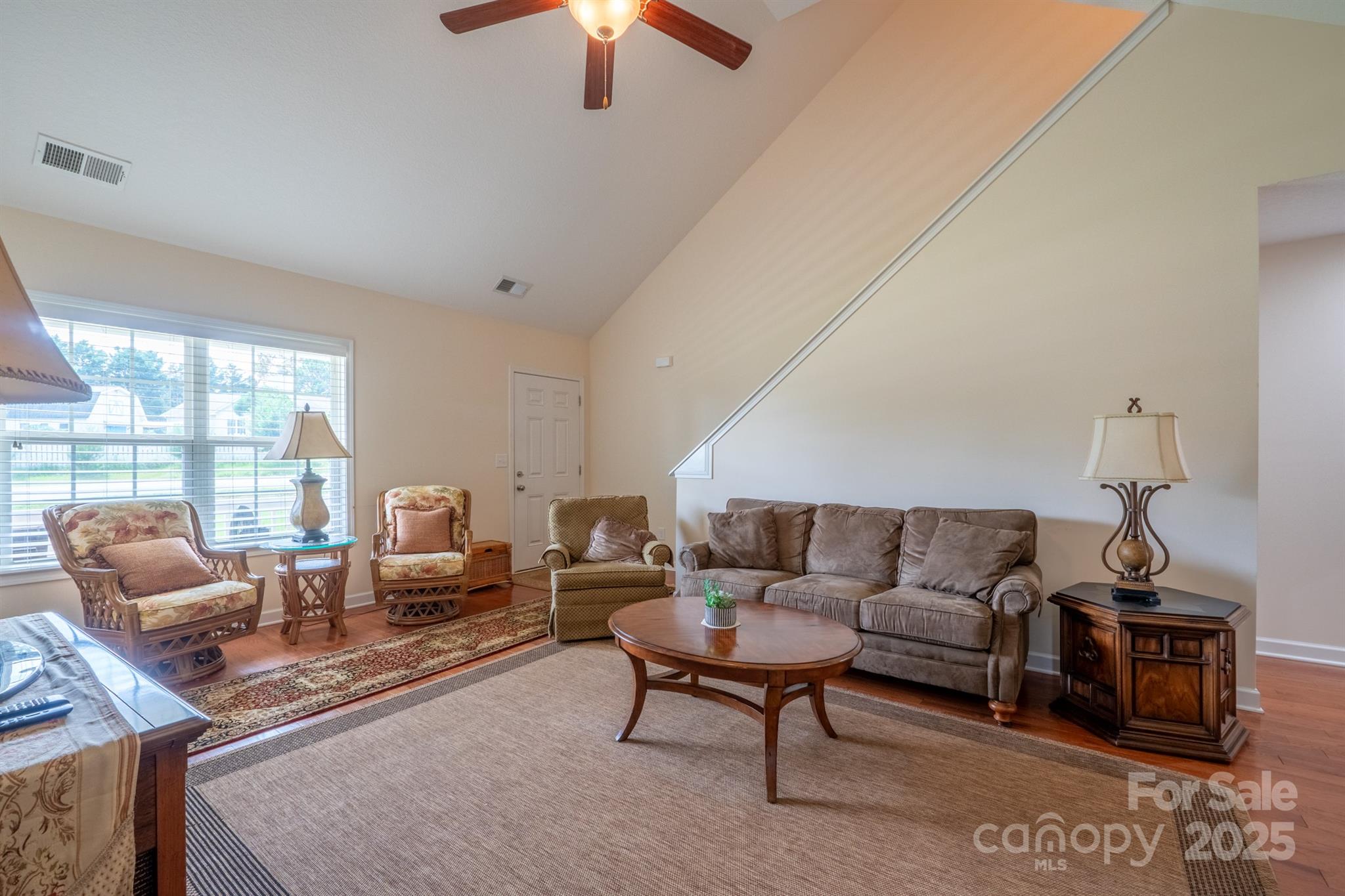 1812 Sam Smith Road Fort Mill, SC 29708 - Photo 9 of 43 a living room with furniture a ceiling fan and a window