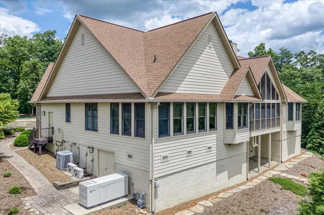 a front view of a house with a yard and trees
