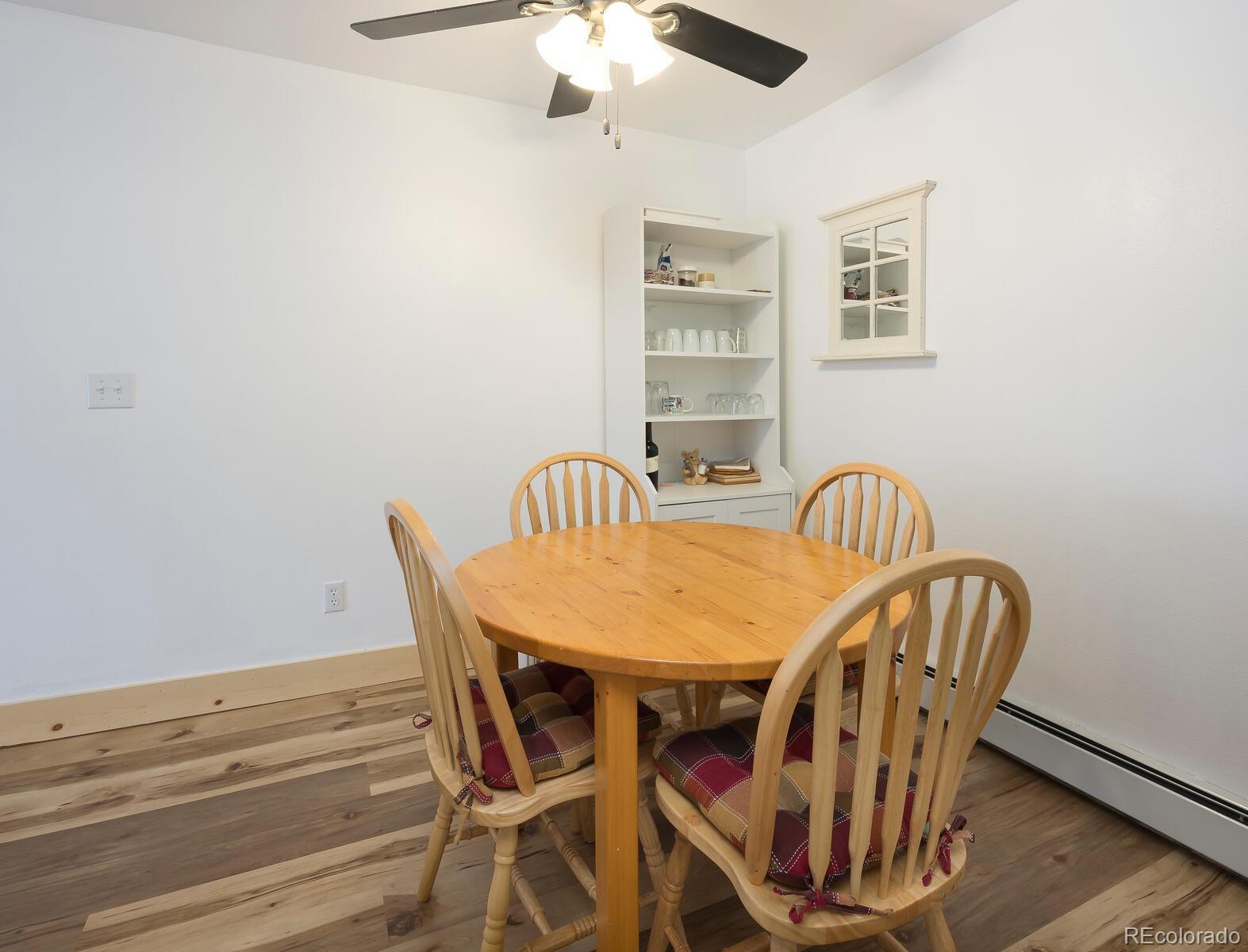 10000 Ryan Gulch Road, Unit 105 Silverthorne, CO 80498 - Photo 11 of 40 a view of a dining room with furniture and wooden floor