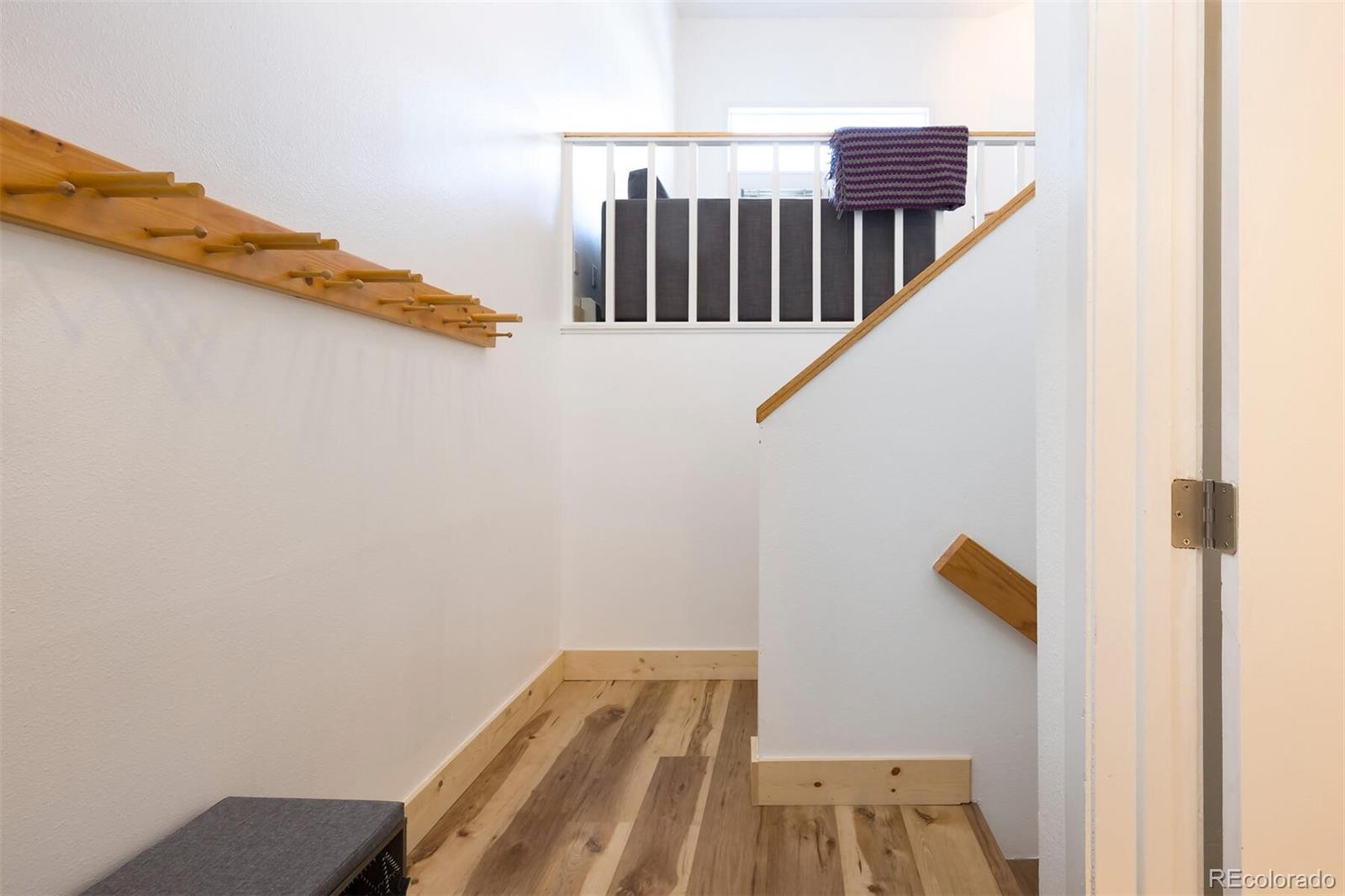 10000 Ryan Gulch Road, Unit 105 Silverthorne, CO 80498 - Photo 2 of 40 a view of a balcony with wooden floor