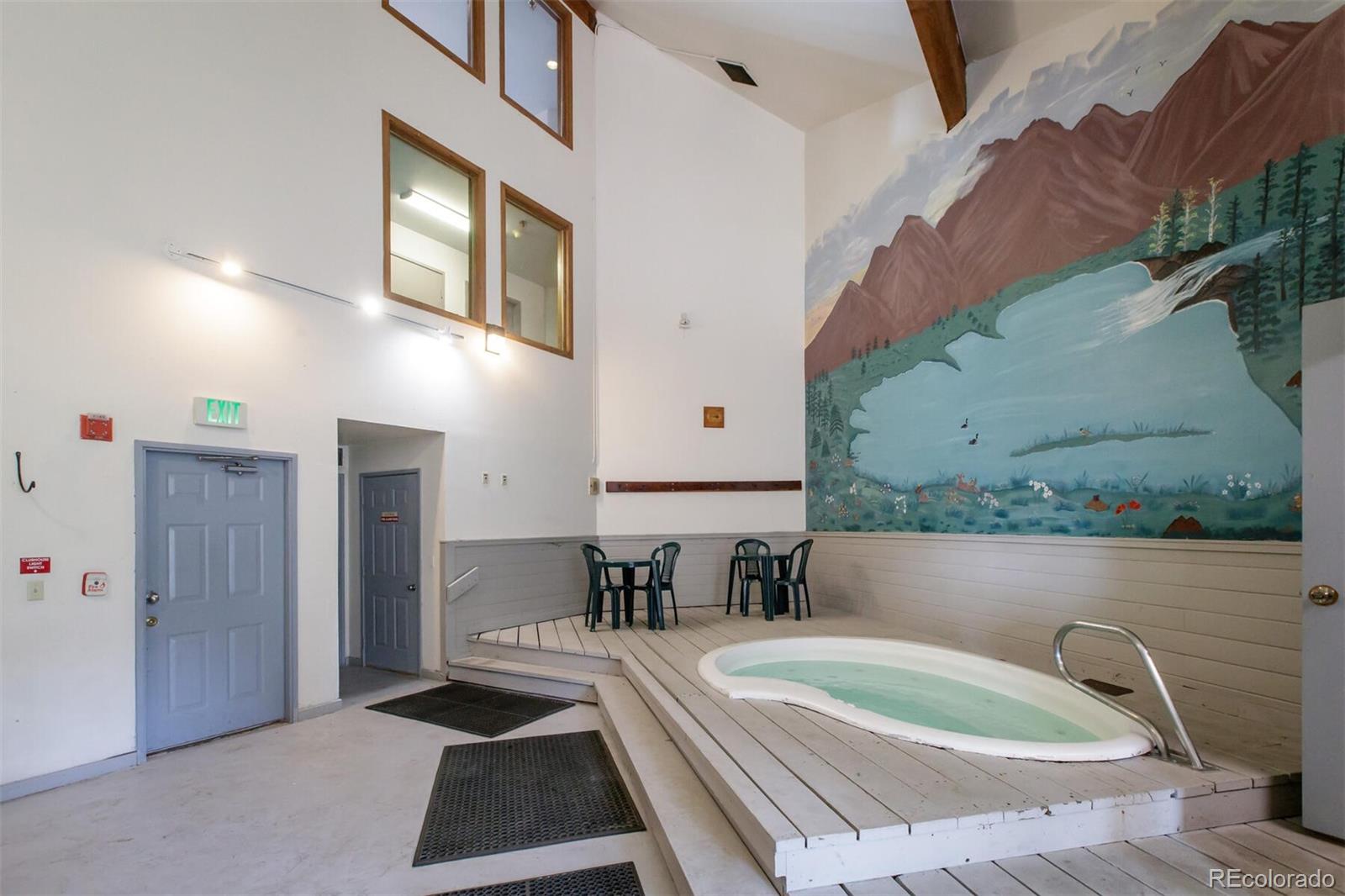 10000 Ryan Gulch Road, Unit 105 Silverthorne, CO 80498 - Photo 36 of 40 a bathroom with a tub a sink and a mirror