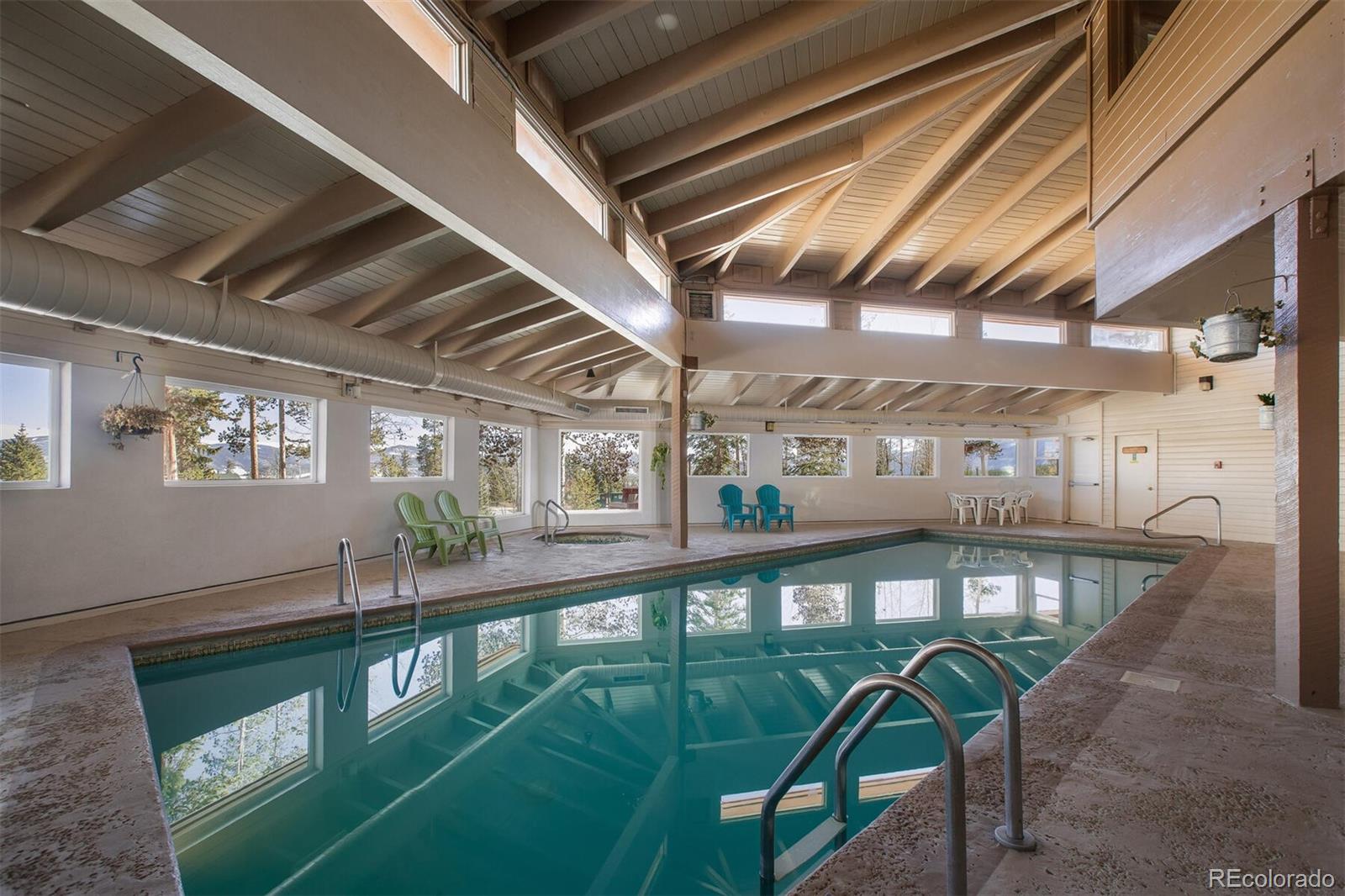 10000 Ryan Gulch Road, Unit 105 Silverthorne, CO 80498 - Photo 40 of 40 a view of a swimming pool with a dining table and chairs