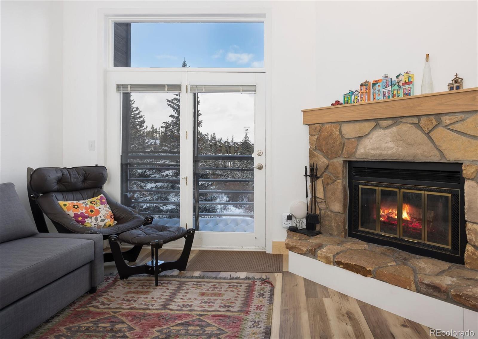 10000 Ryan Gulch Road, Unit 105 Silverthorne, CO 80498 - Photo 4 of 40 a living room with furniture and a fireplace