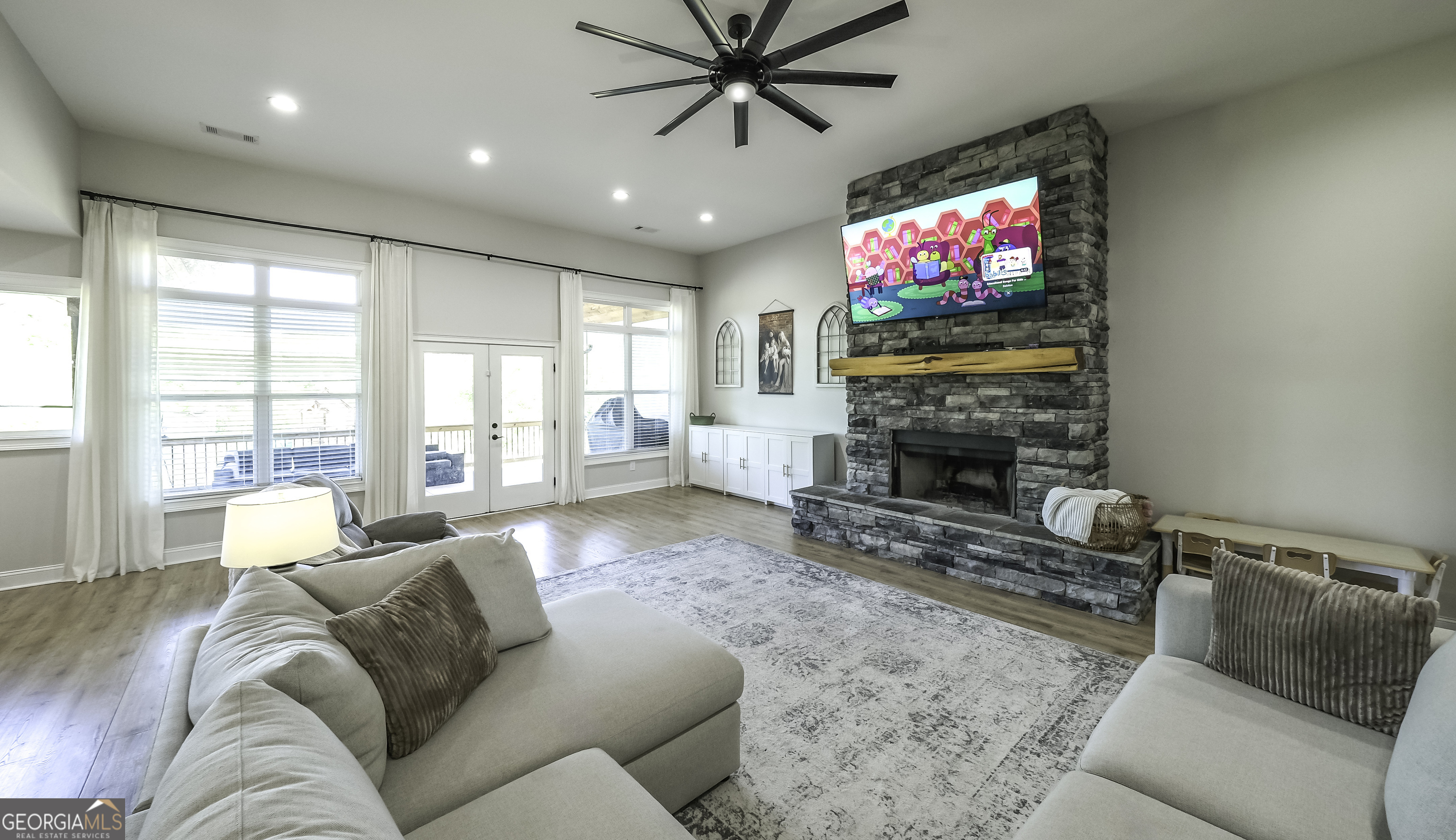 2392 Welcome Road Roopville, GA 30170 - Photo 14 of 43 a living room with furniture a flat screen tv and a fireplace