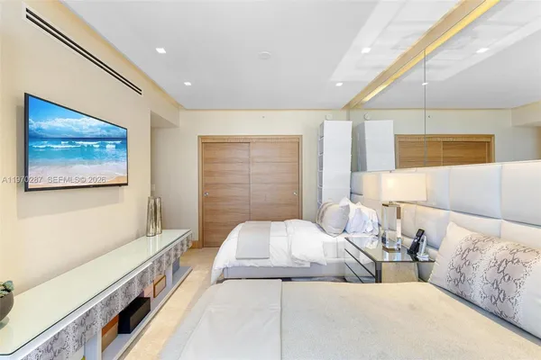 a bedroom with two beds and a large window