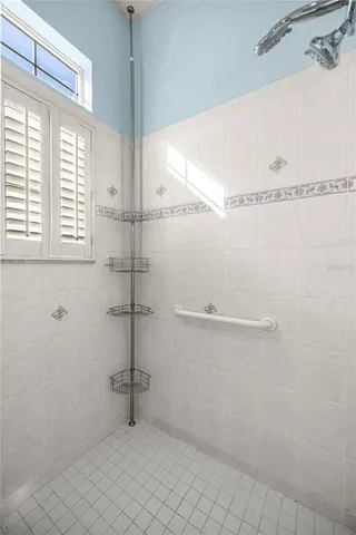 a bathroom with a window and a shower