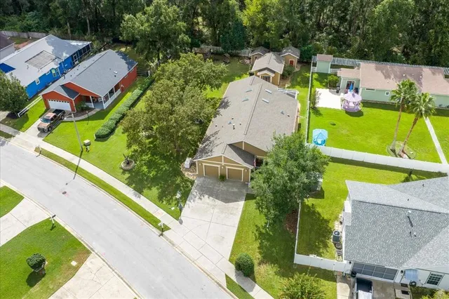 an aerial view of a house with a garden and swimming pool