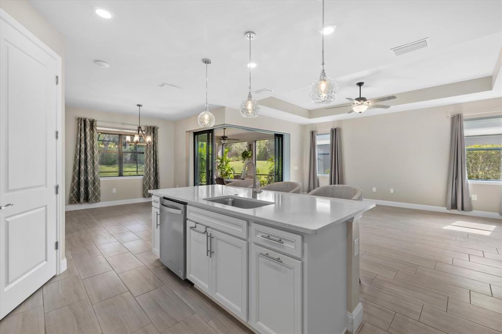 6835 Chester Trail Bradenton, FL 34202 - Photo 18 of 40 a kitchen with kitchen island granite countertop a sink and a stove