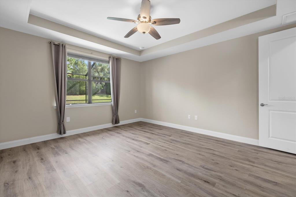 6835 Chester Trail Bradenton, FL 34202 - Photo 23 of 40 an empty room with wooden floor and windows