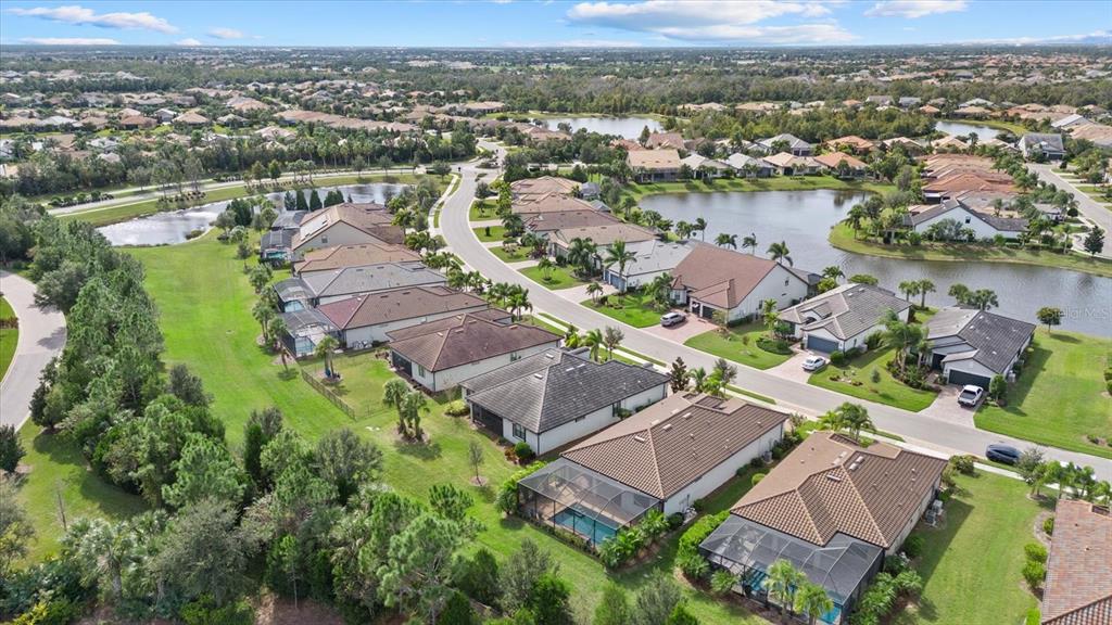 6835 Chester Trail Bradenton, FL 34202 - Photo 40 of 40 an aerial view of lake with residential house with swimming pool and ocean view