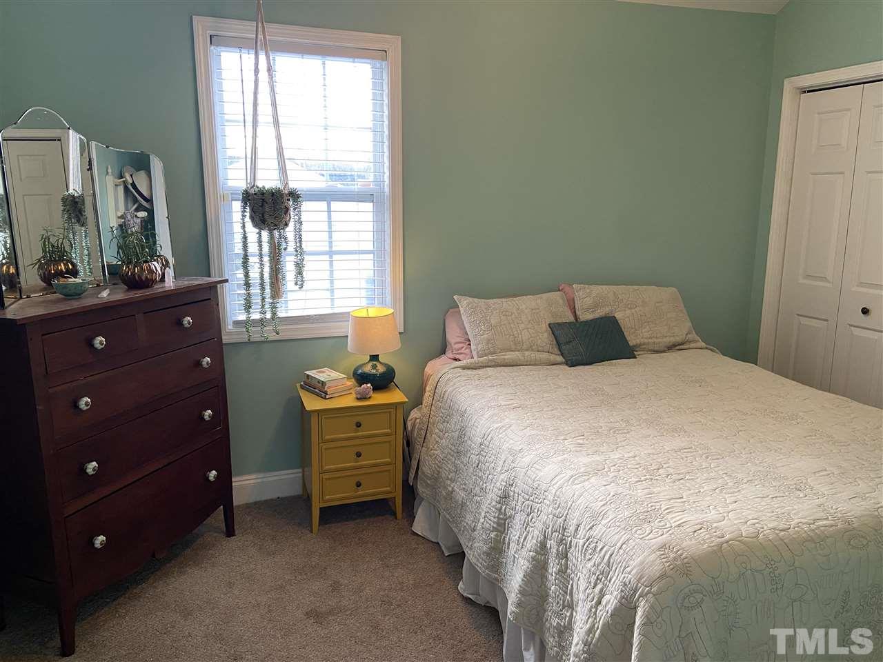 910 East Jones Street Raleigh, NC 27601 - Photo 11 of 23 a bedroom with a bed and a window