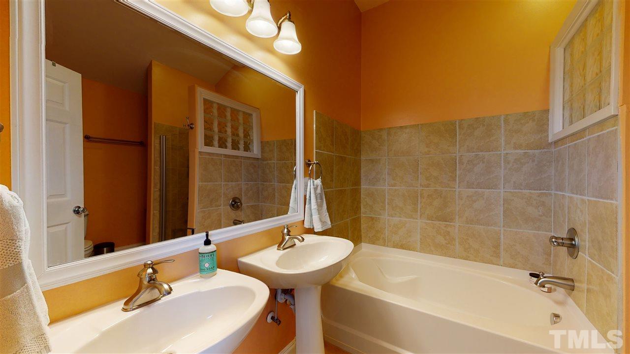910 East Jones Street Raleigh, NC 27601 - Photo 13 of 23 a bathroom with a sink and a bathtub