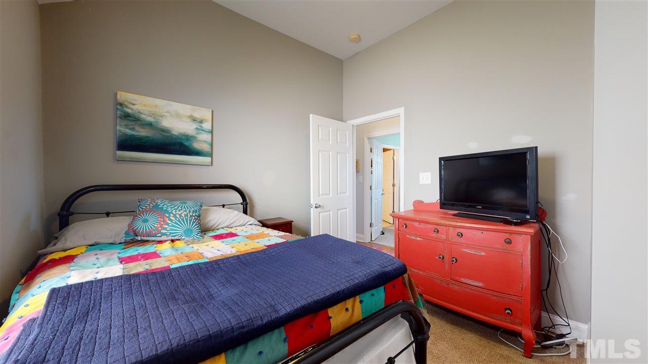 910 East Jones Street Raleigh, NC 27601 - Photo 16 of 23 a bedroom with a bed and a flat screen tv
