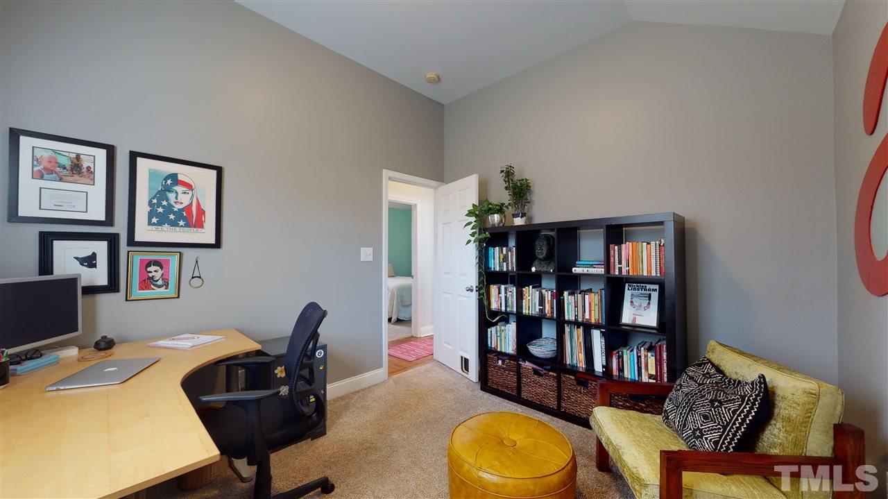 910 East Jones Street Raleigh, NC 27601 - Photo 18 of 23 a view of a workspace with furniture and a bookshelf
