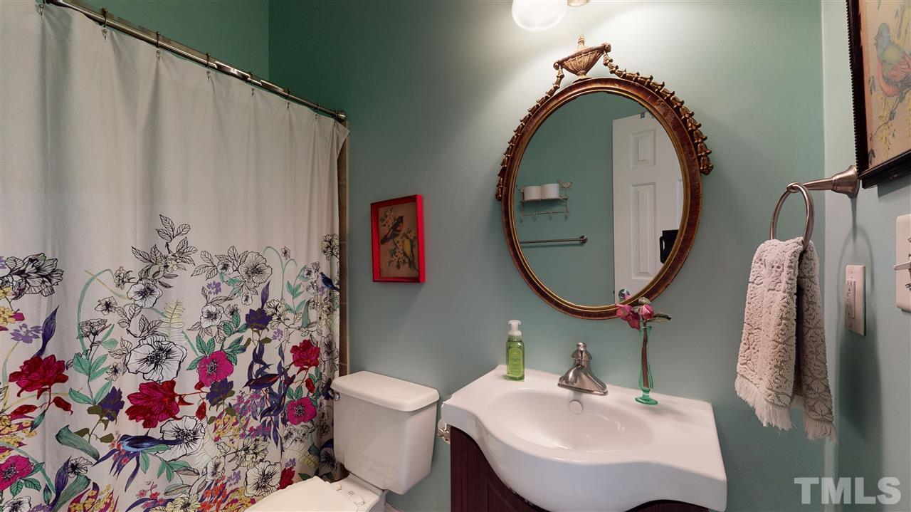 910 East Jones Street Raleigh, NC 27601 - Photo 19 of 23 a bathroom with a sink mirror and toilet