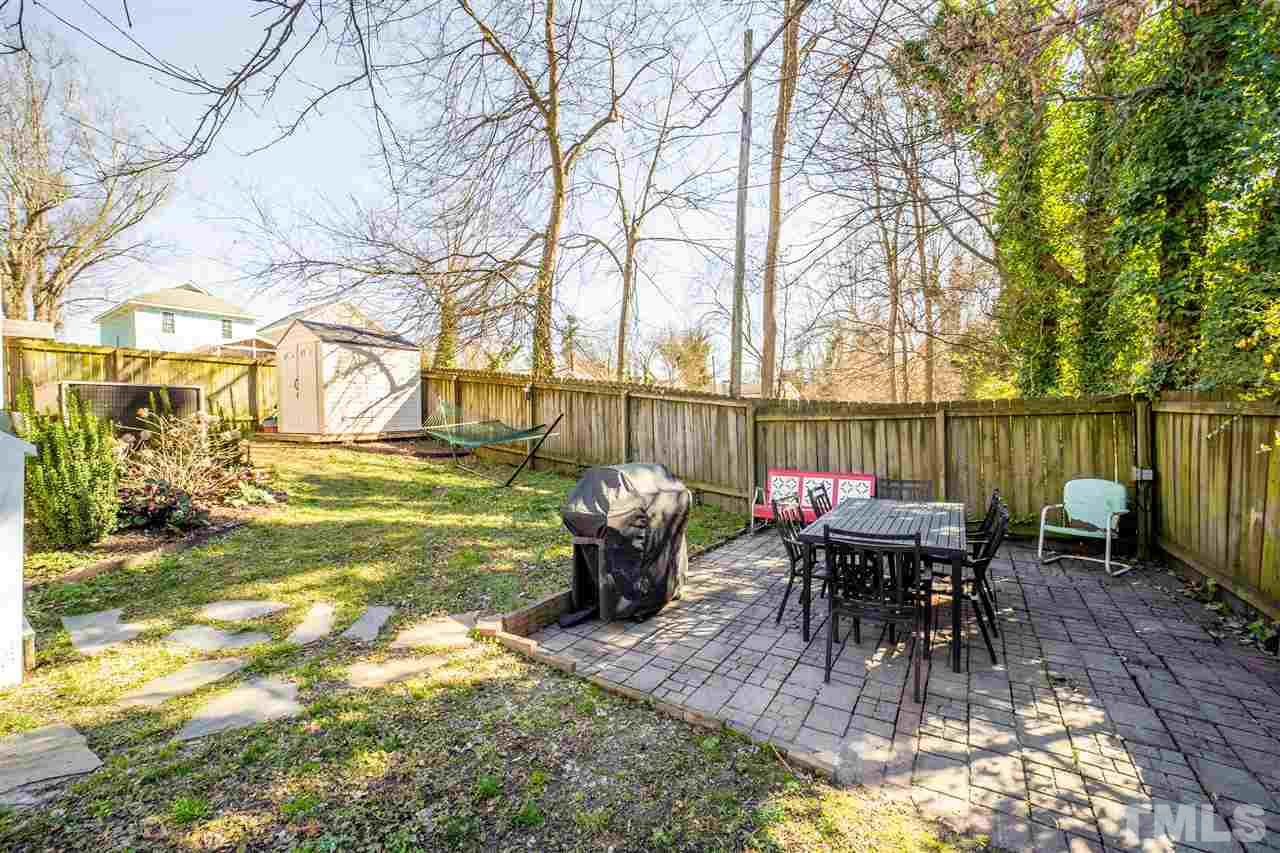 910 East Jones Street Raleigh, NC 27601 - Photo 23 of 23 a view of a patio with table and chairs potted plants and large tree