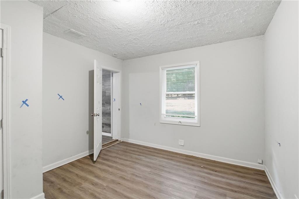 192 Highway 138 Stockbridge, GA 30281 - Photo 12 of 23 an empty room with wooden floor and windows