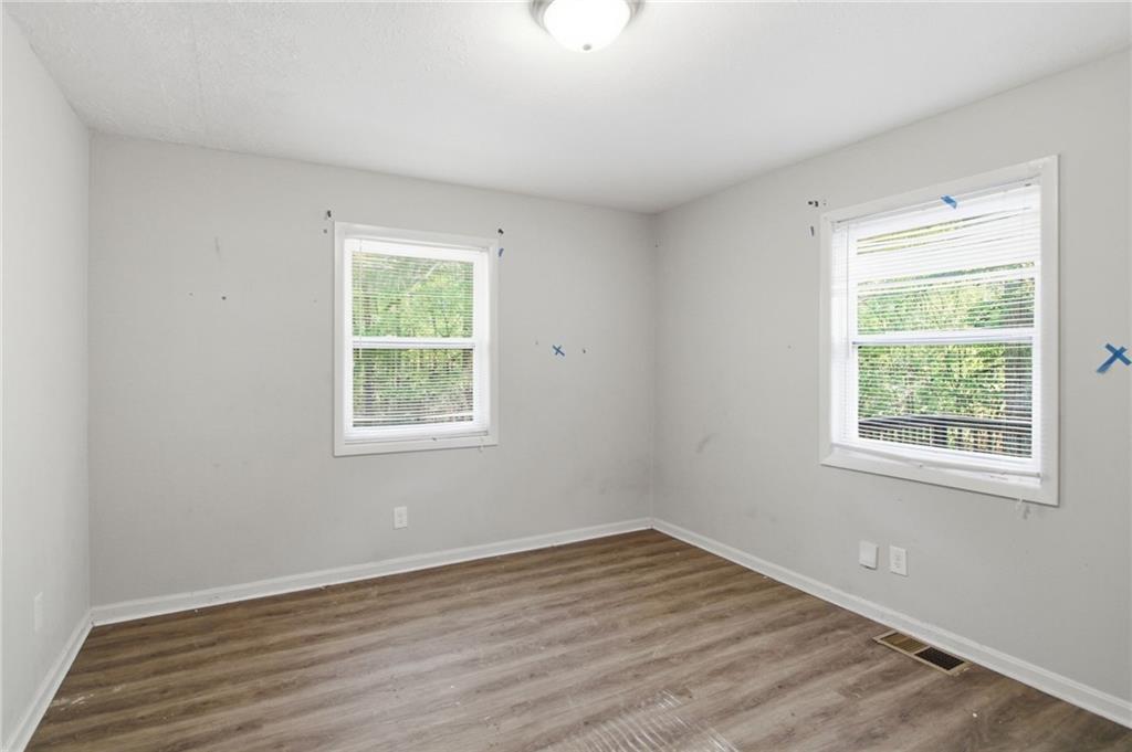 192 Highway 138 Stockbridge, GA 30281 - Photo 14 of 23 an empty room with wooden floor and windows