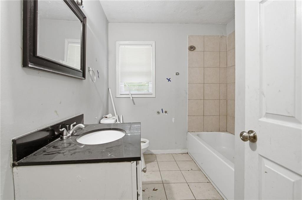 192 Highway 138 Stockbridge, GA 30281 - Photo 17 of 23 a bathroom with a granite countertop sink and a bathtub