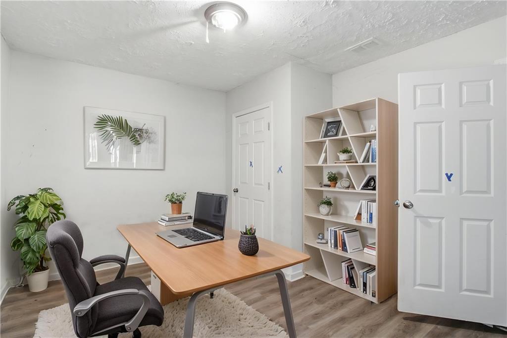 192 Highway 138 Stockbridge, GA 30281 - Photo 4 of 23 a workspace with furniture and bookshelf