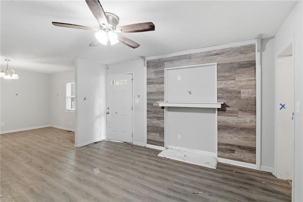 192 Highway 138 Stockbridge, GA 30281 - Photo 9 of 23 an empty room with wooden floor and a ceiling fan