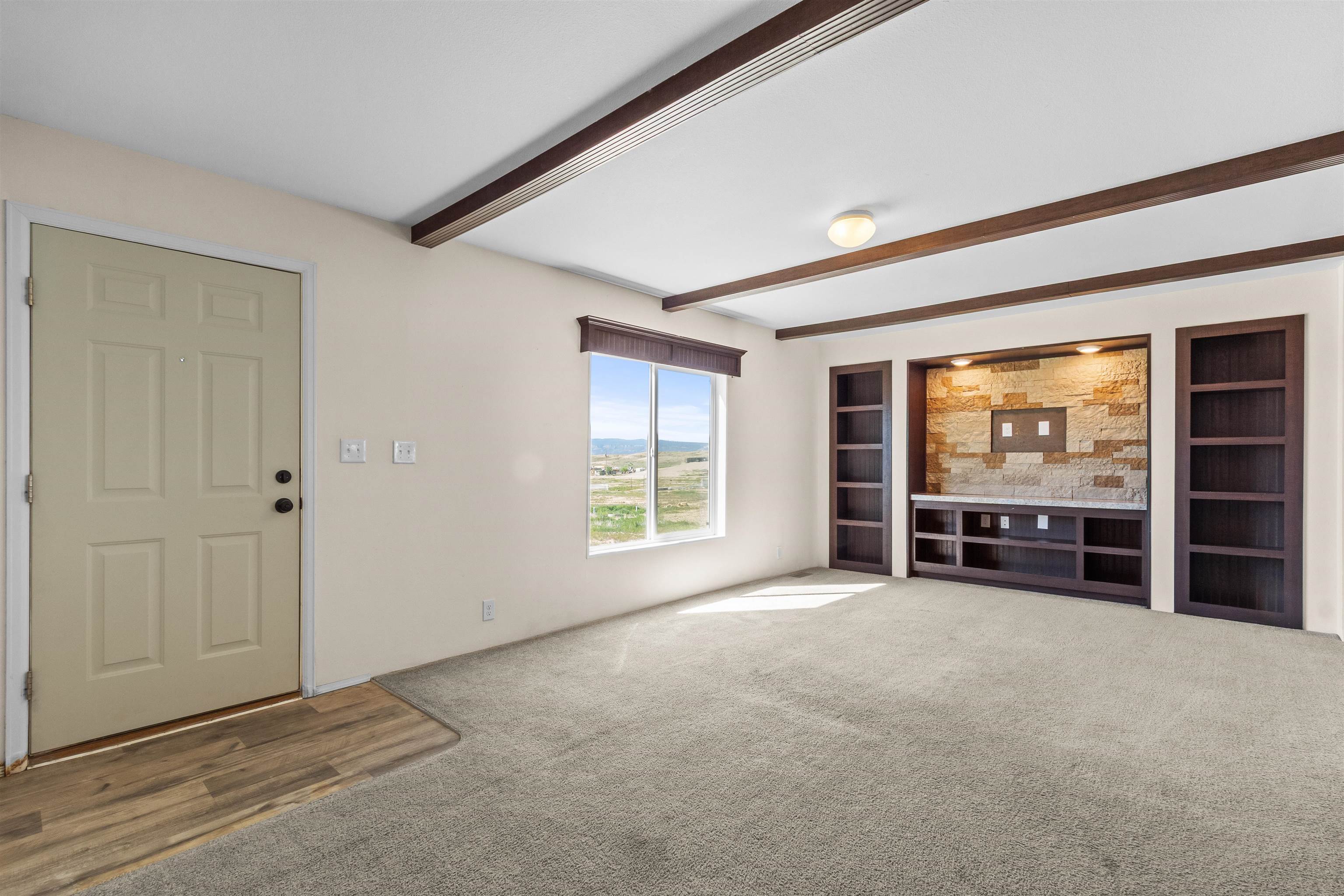 759 33 Road Clifton, CO 81520 - Photo 7 of 35 an empty room with furniture and large windows