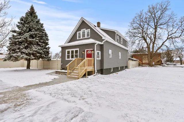 a view of a house with a yard covered in snow