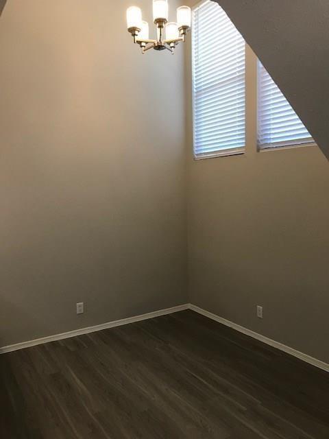 18240 Midway Road, Unit 303 Dallas, TX 75287 - Photo 8 of 21 High ceilings with a five-light chandelier, dual windows with horizontal blinds, and wood-finish flooring